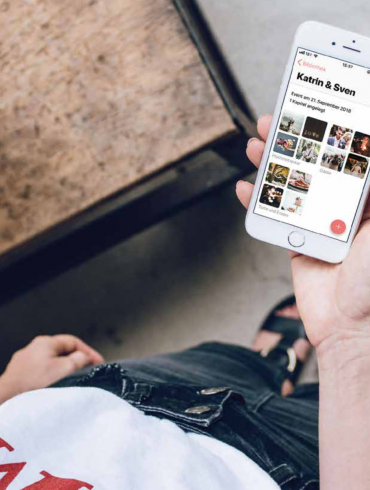 Person, die ein Smartphone mit Fotos in der Hand hält